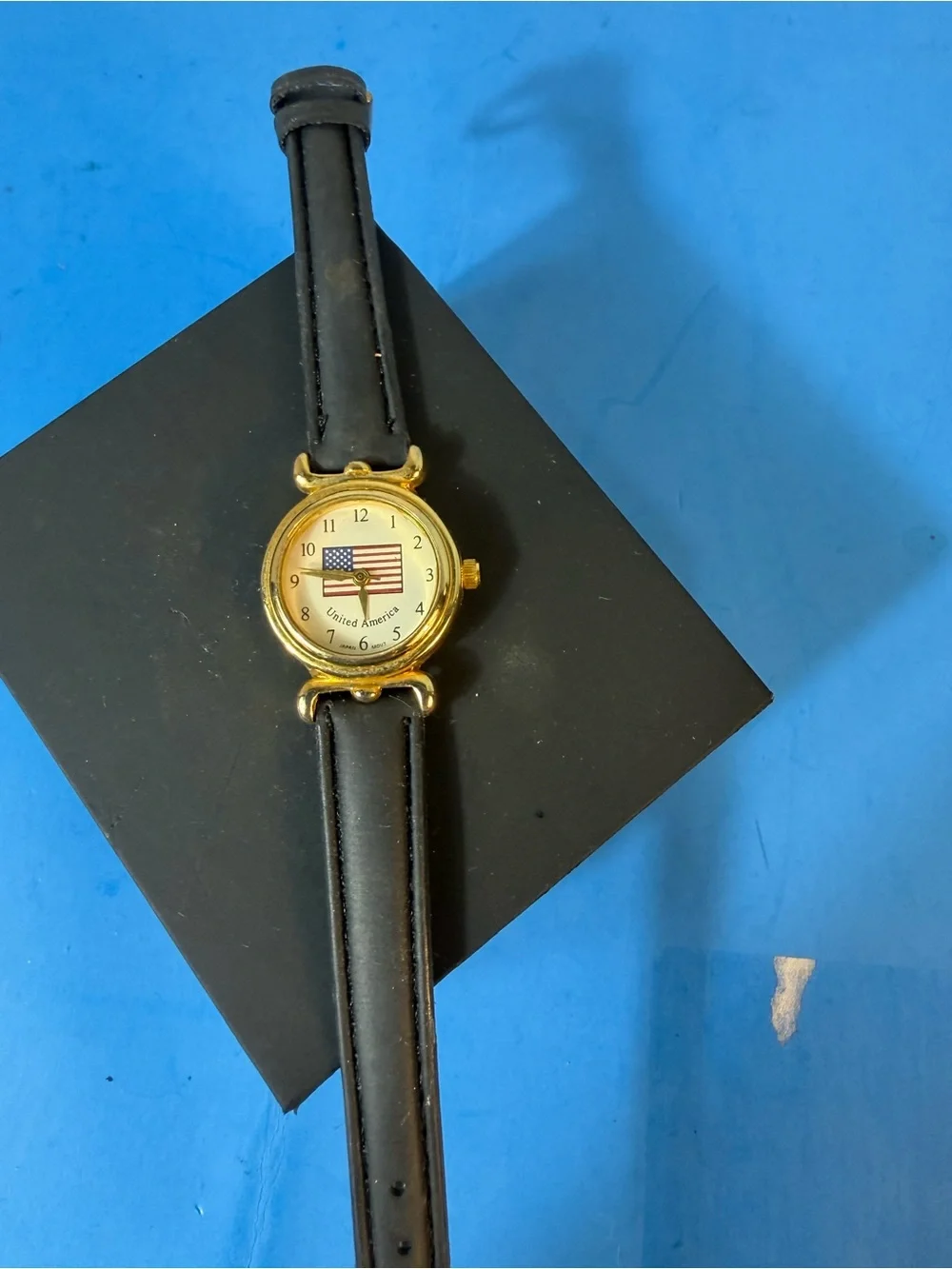 Gold Dial Black Leather Strap Women's Watch with American Flag Accent